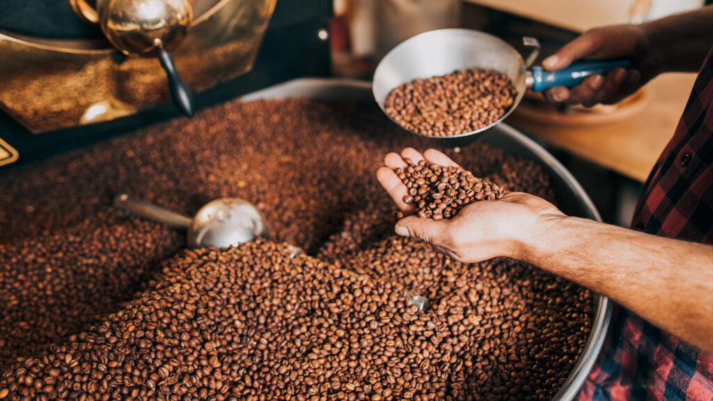 Coffee beans being roasted by a man